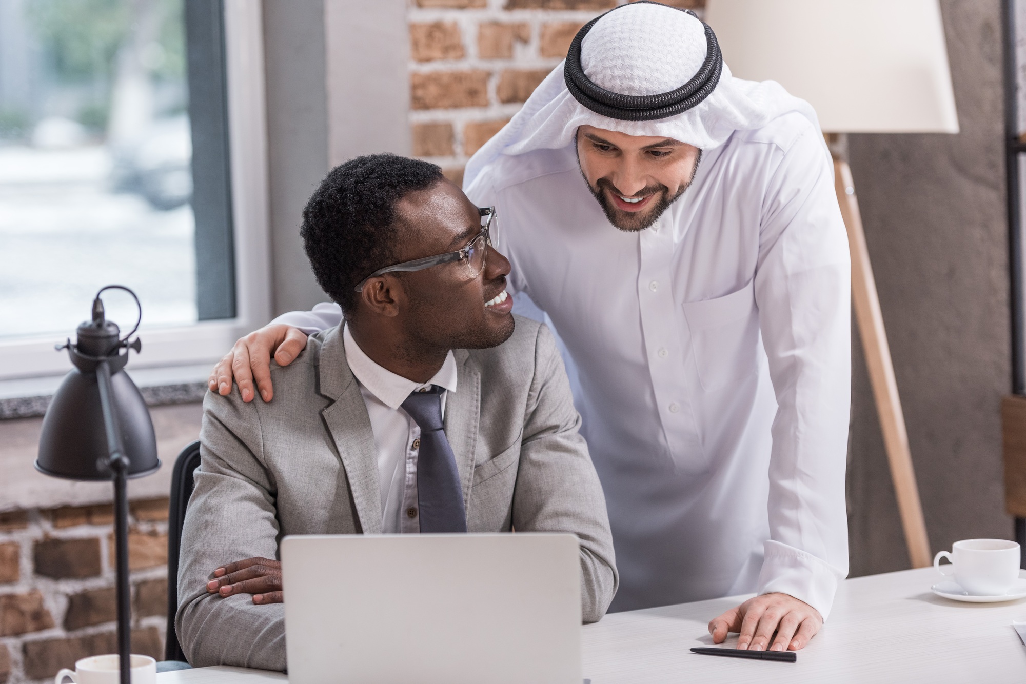 African american businessman looking at arabian partner in office